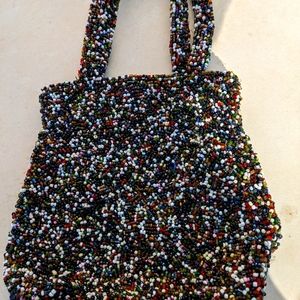 Small Moyna brand  multi beaded purse. Silk inside.